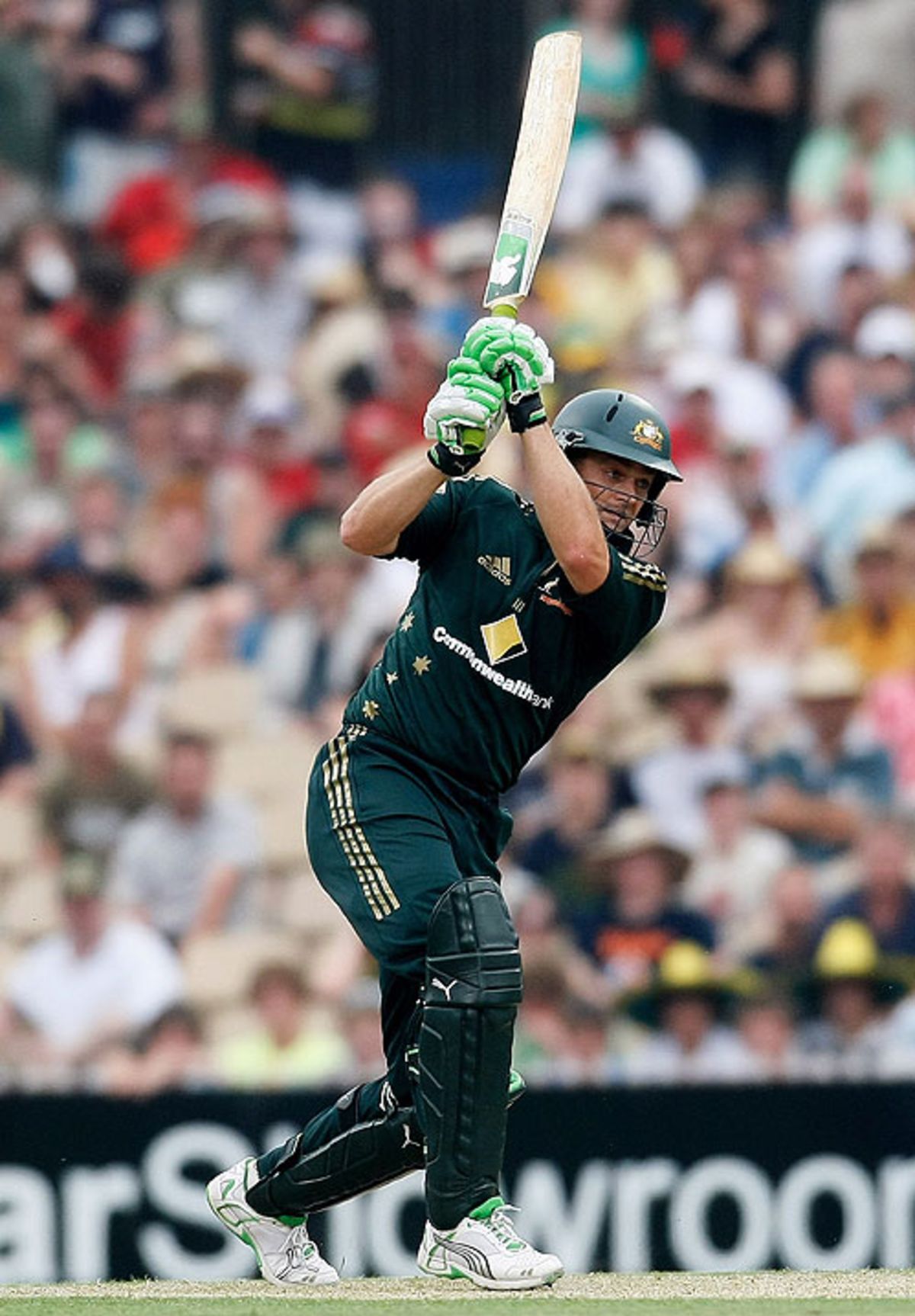 Adam Gilchrist drives down the ground