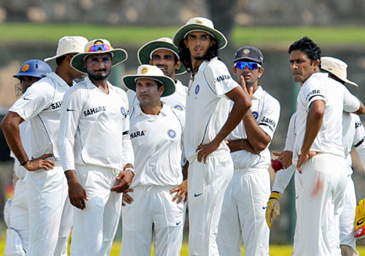 Indian players wait for a thirdumpire review for a legbefore appeal against Malinda Warnapura