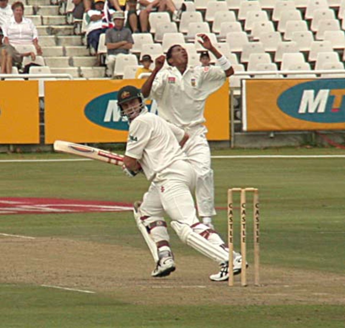 Jacques Kallis in full flight with ,umpire Steve Bucknor looking on 