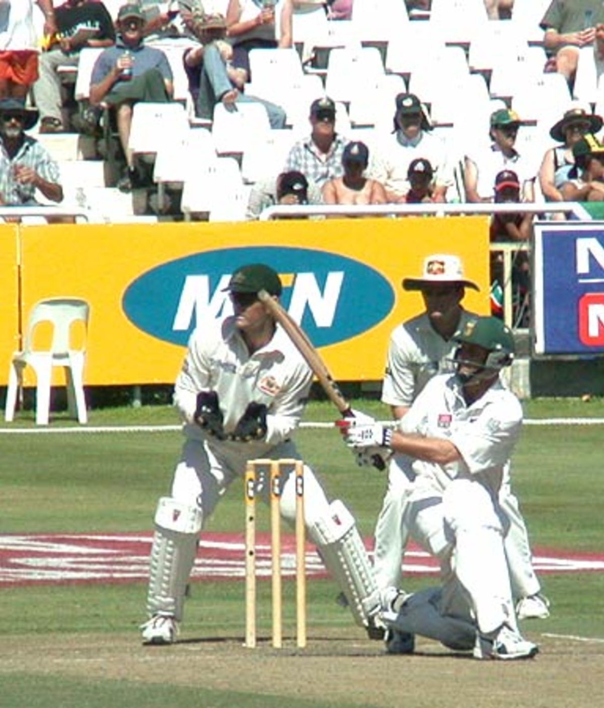 Brett Lee In Full Flight While Umpire Rudi Koertzen Looks On