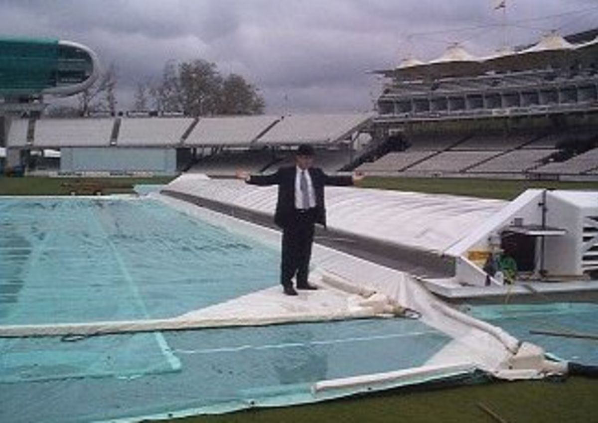Justin Langer stands on the wet Lord's ground during a county match which was abandoned after 4 days of rain. 1999.