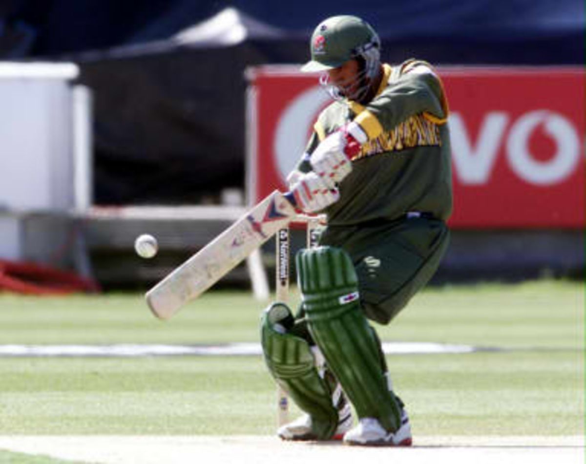 Bangladesh opening batsman Mehrab Hossain hits out off the bowling of Australia's Damien Fleming 27 May 1999, during their Cricket World Cup match at Chester le Street