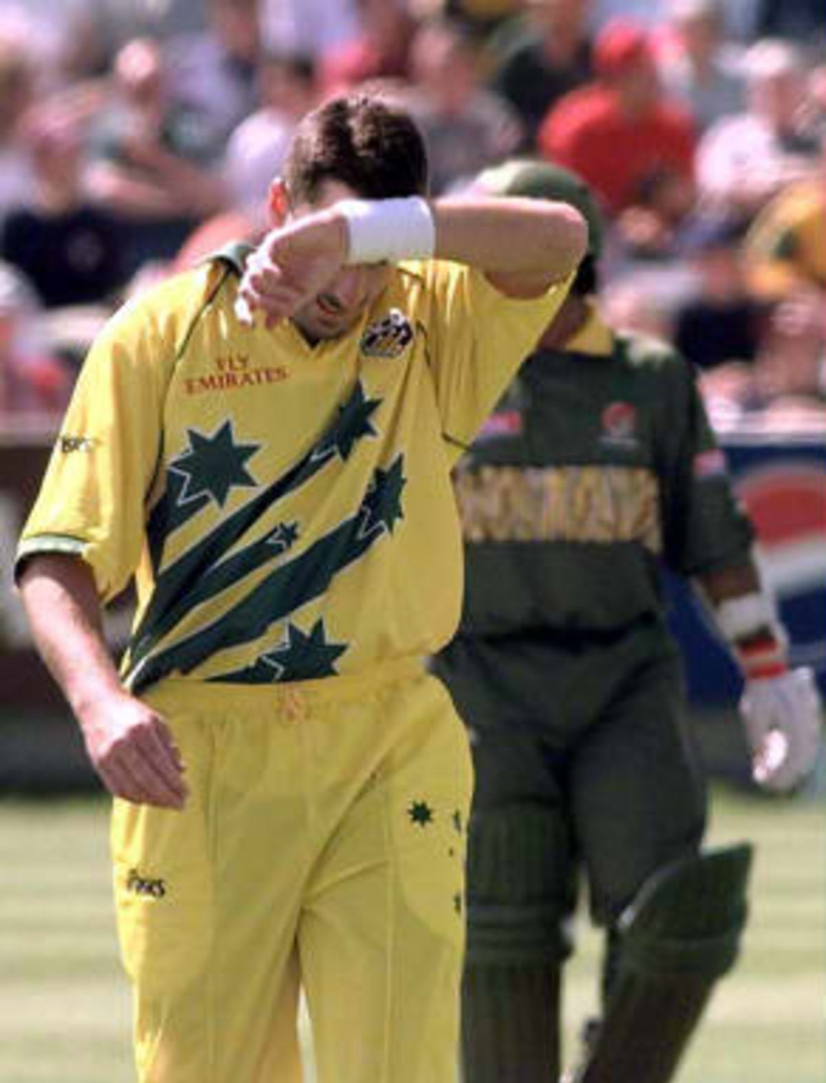 Australian bowler Damien Fleming wipes his forehead as Bangladesh make a spirited start to their innings during their Cricket World Cup match at Chester-le-Street, Durham  27 May 1999
