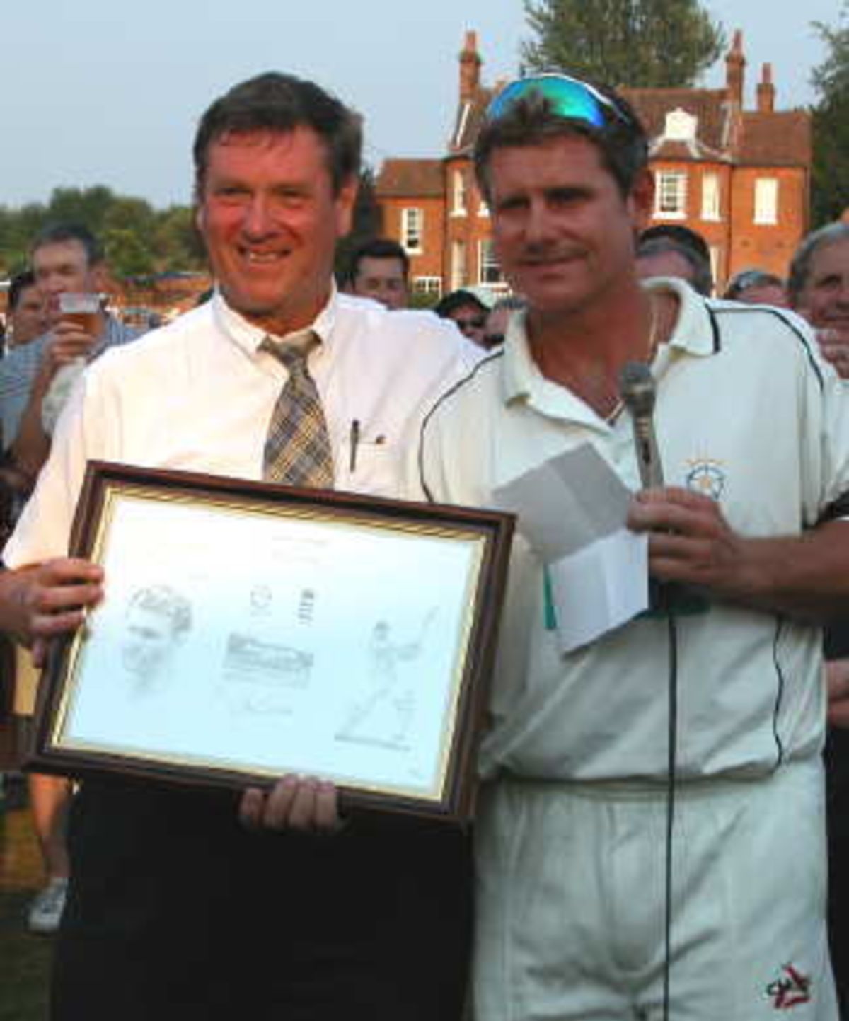 Bob Jeavons-Fellows, President of Hartley Wintney Cricket Club receives a Testimonial Print in gratitude from Robin Smith