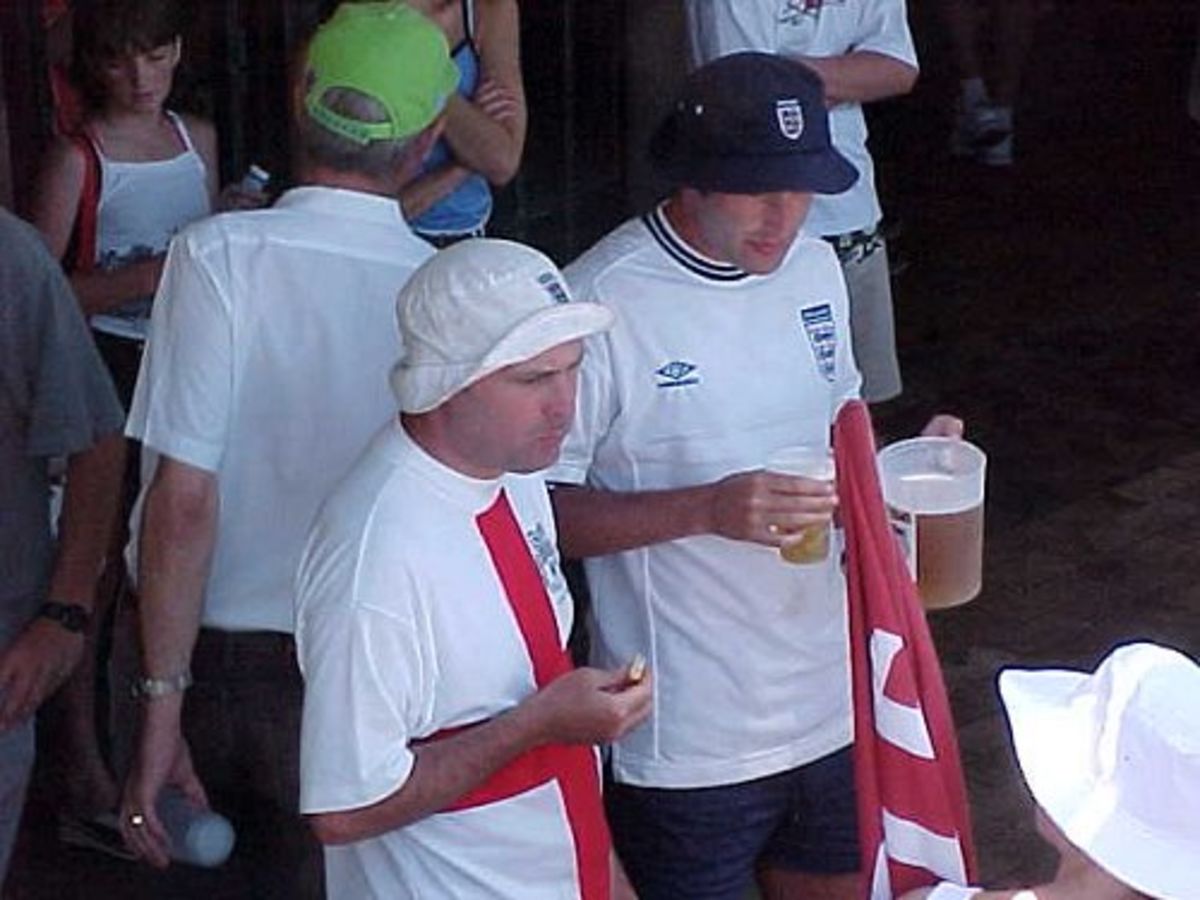 Members of England's touring fancclub, the "Barmy Army", watch the start of the South African second innings on the fourth day of the Second Test in Port Elizabeth (12 December 1999)