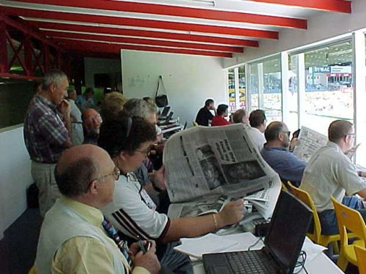 Members of the press follow play on day four of the Second Test between England and South Africa in Port Elizabeth. (12 December 1999)