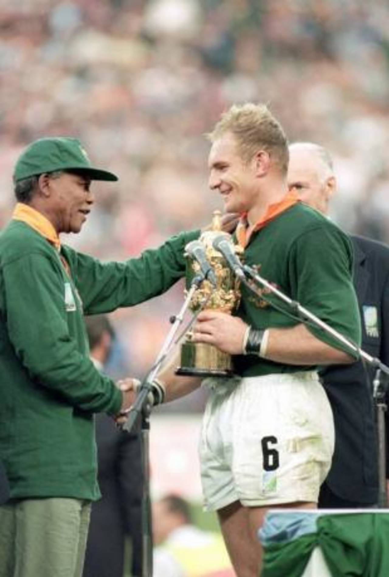 South Africa captain Francois Pienaar receives the rugby World Cup from President Nelson Mandela, Ellis Park, Johannesburg, 24 June 1995