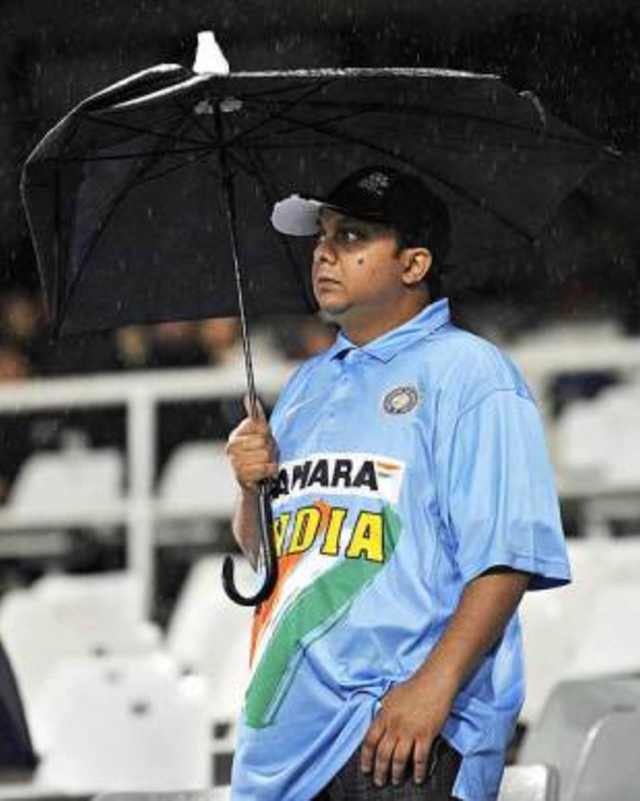 A fan who won India many games by holding a broken umbrella with his other hand in his pocket and all three buttons on his replica shirt done up&nbsp;&nbsp;&bull;&nbsp;&nbsp;AFP