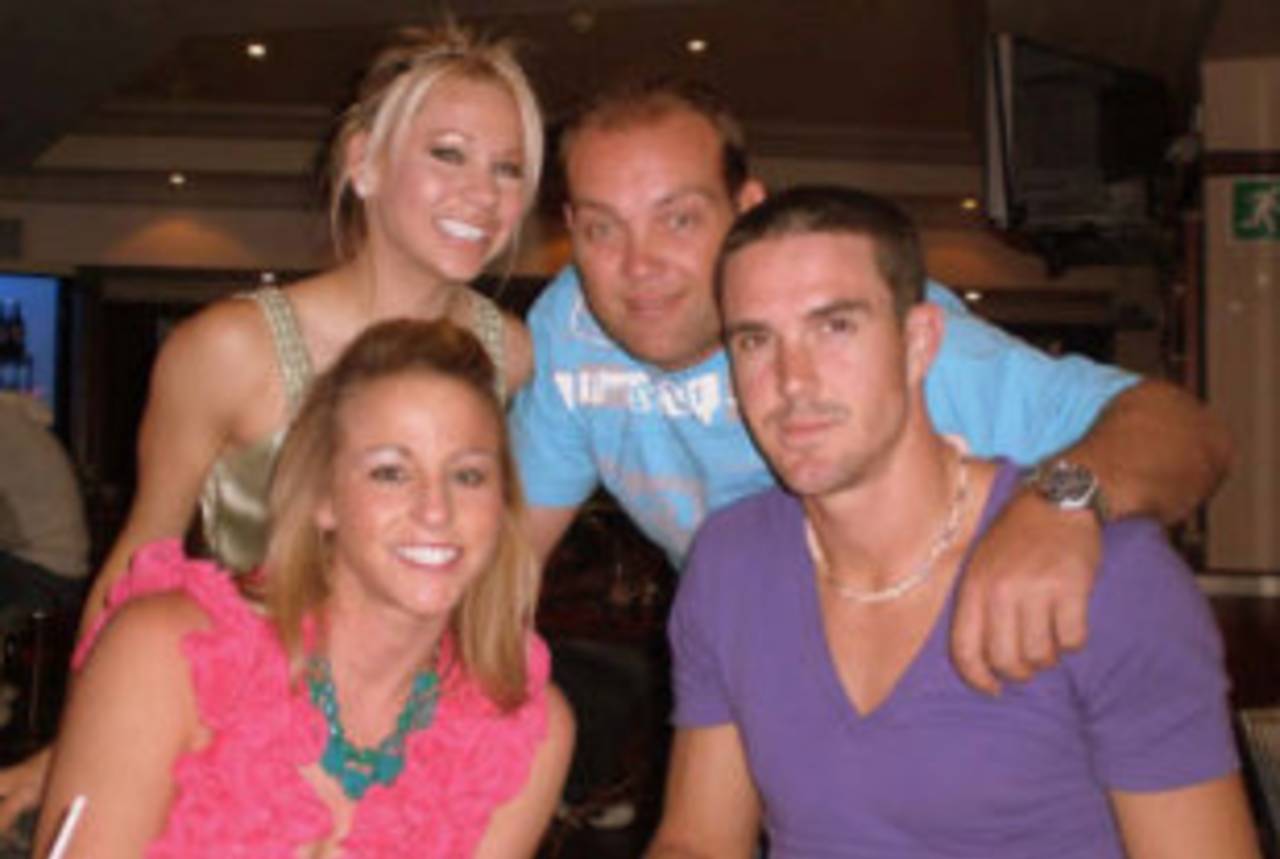 Jacques Kallis and Kevin Pietersen with two members of Royal Challengers Bangalore's Mischief Gals cheerleader squad