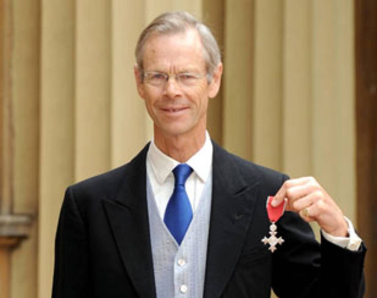 Broadcaster and journalist Christopher Martin-Jenkins poses outside Buckingham Palace after receiving his MBE, London, May 28, 2009 