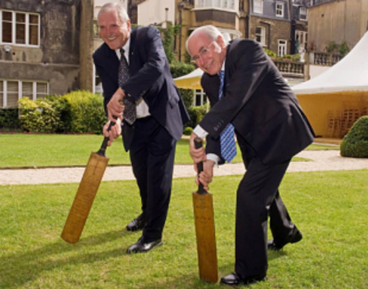 Defence minister: John Howard, right, tries out one of Don Bradman's bats&nbsp;&nbsp;&bull;&nbsp;&nbsp;AFP