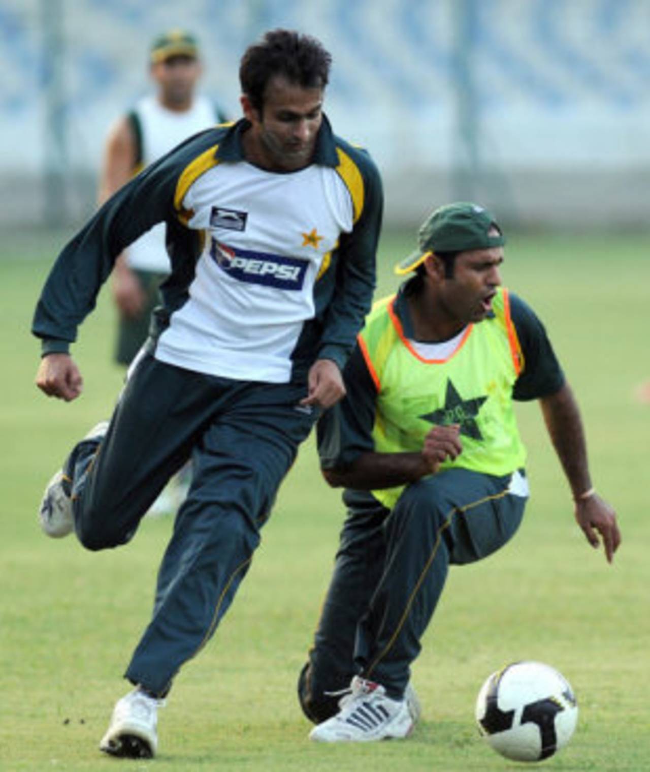 Shoaib Malik and Naved-ul-Hasan play some football during a training camp, National Stadium, Karachi, September 12, 2009
