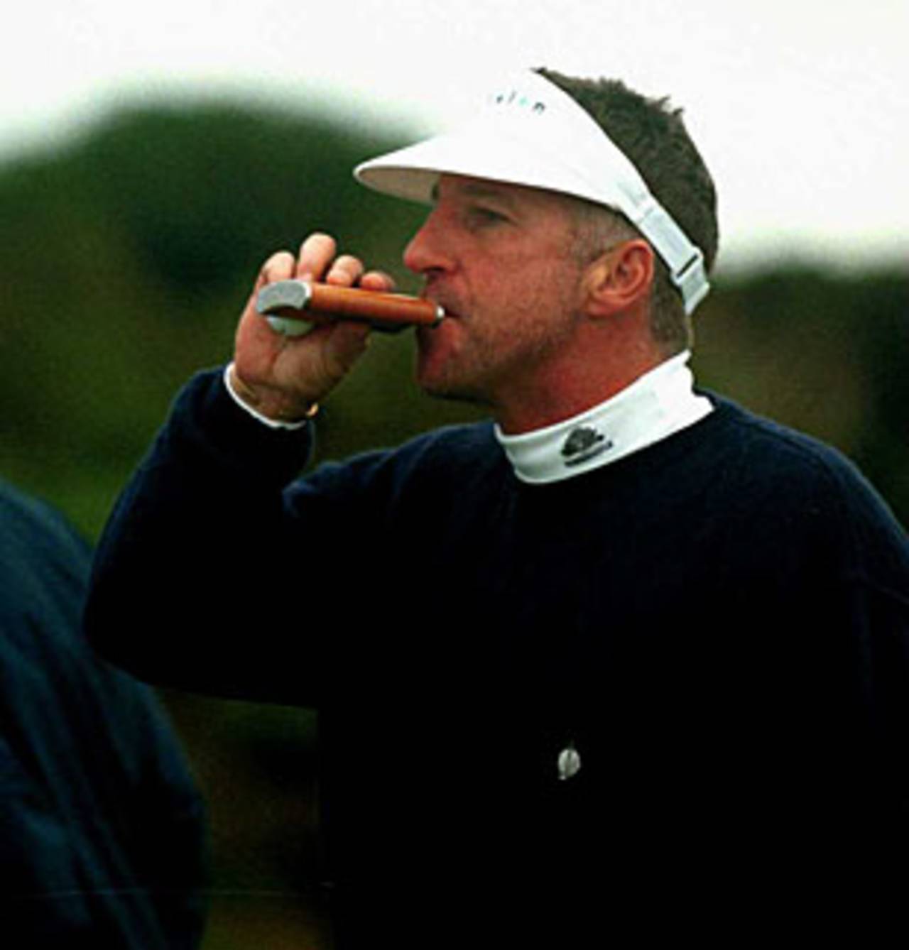 Ian Botham takes a sip from his hip flask as tennis player Ivan Lendl looks on ahead of the Alfred Dunhill Cup, Scotland, October 10, 2000