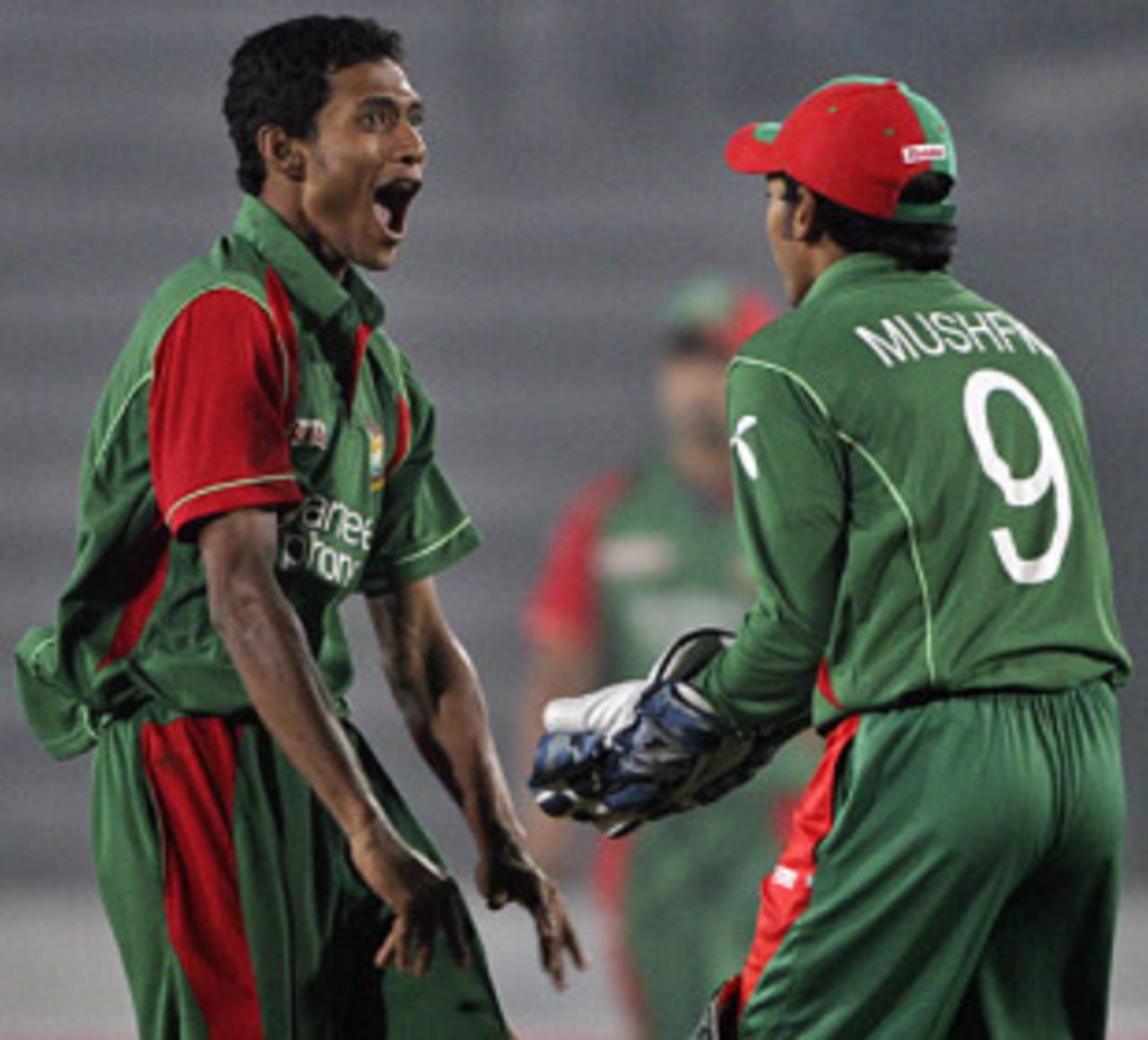 Shafiul Islam and Mushfiqur Rahim are delighted to see the back of Dinesh Karthik, Bangladesh v India, Tri-series, 6th ODI, Mirpur, January 11, 2010