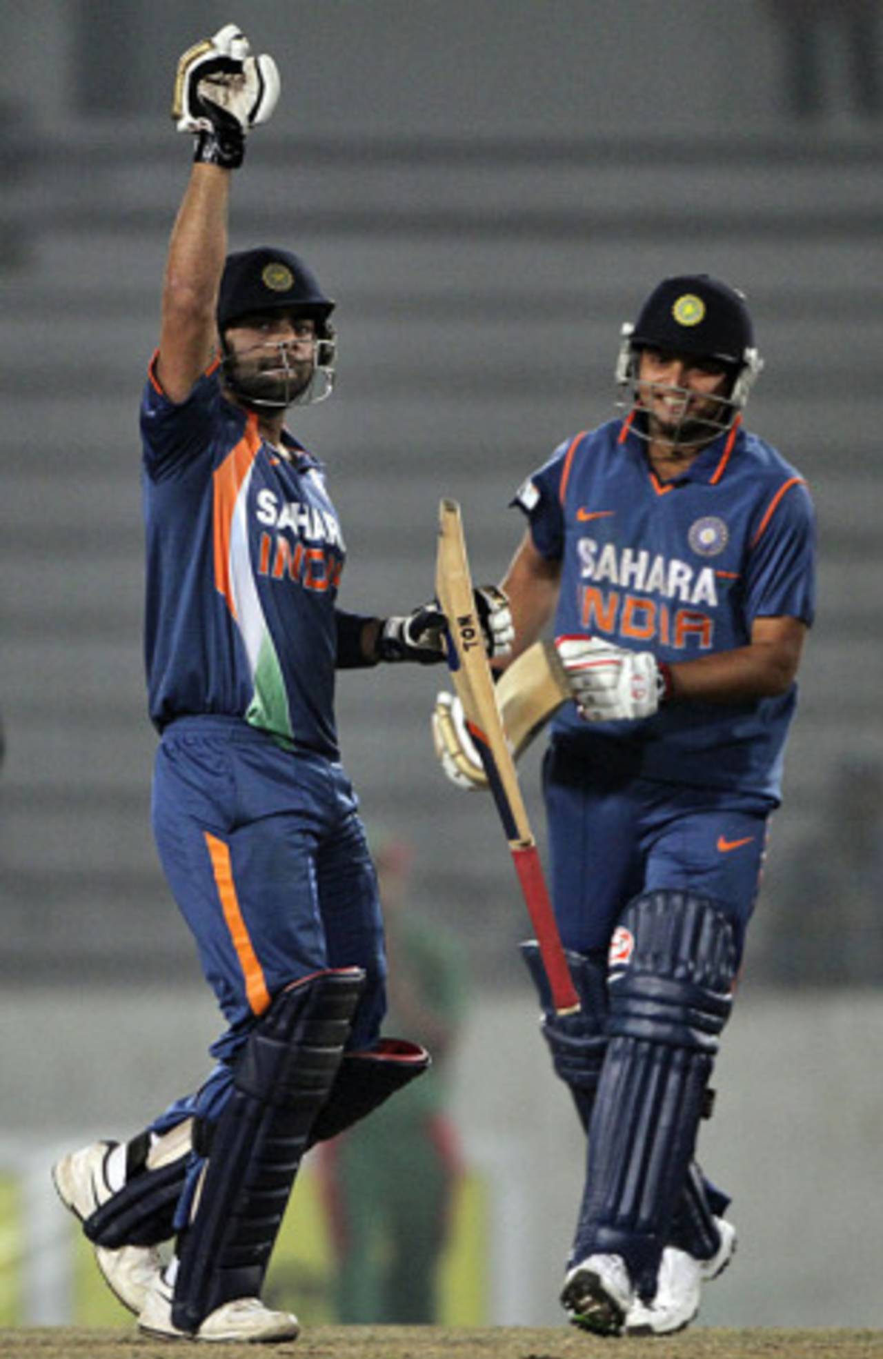 Suresh Raina and Virat Kohli celebrate the latter's ton and victory, Bangladesh v India, Tri-series, 6th ODI, Mirpur, January 11, 2010