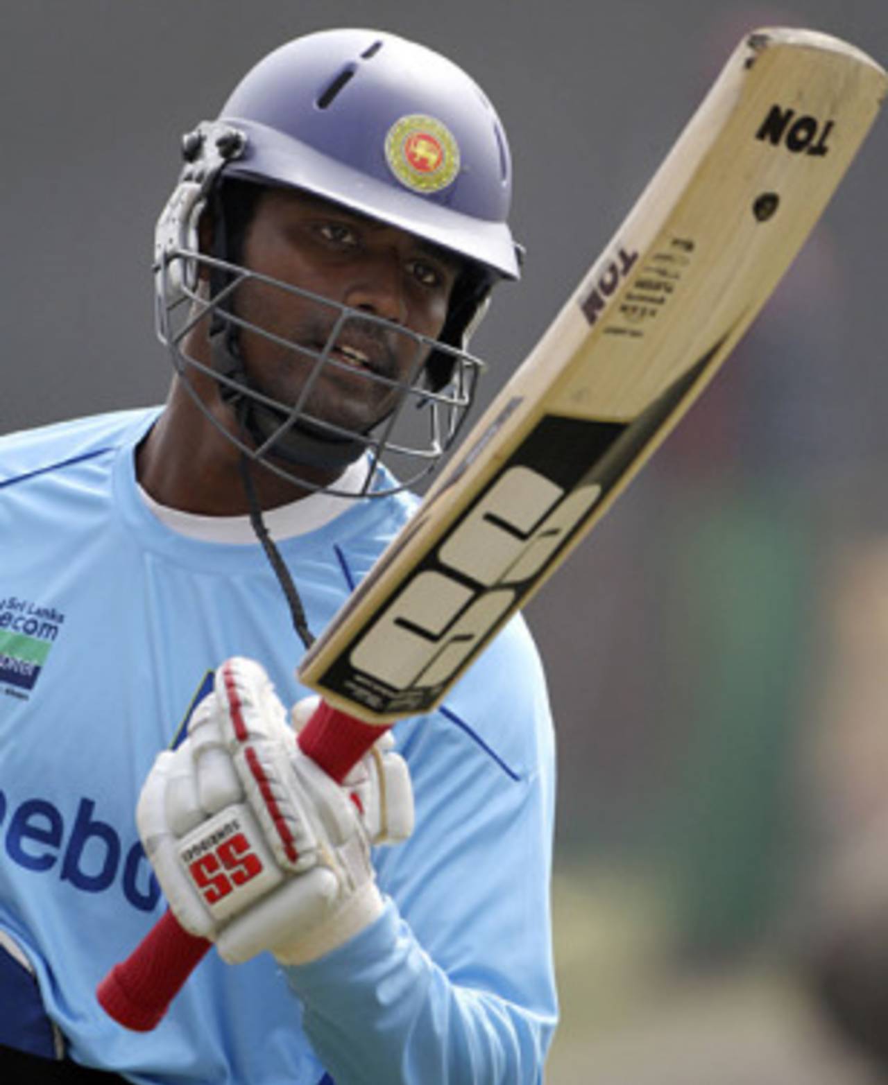 Thissara Perera checks on his bat at the nets session, Dhaka, January 12, 2010