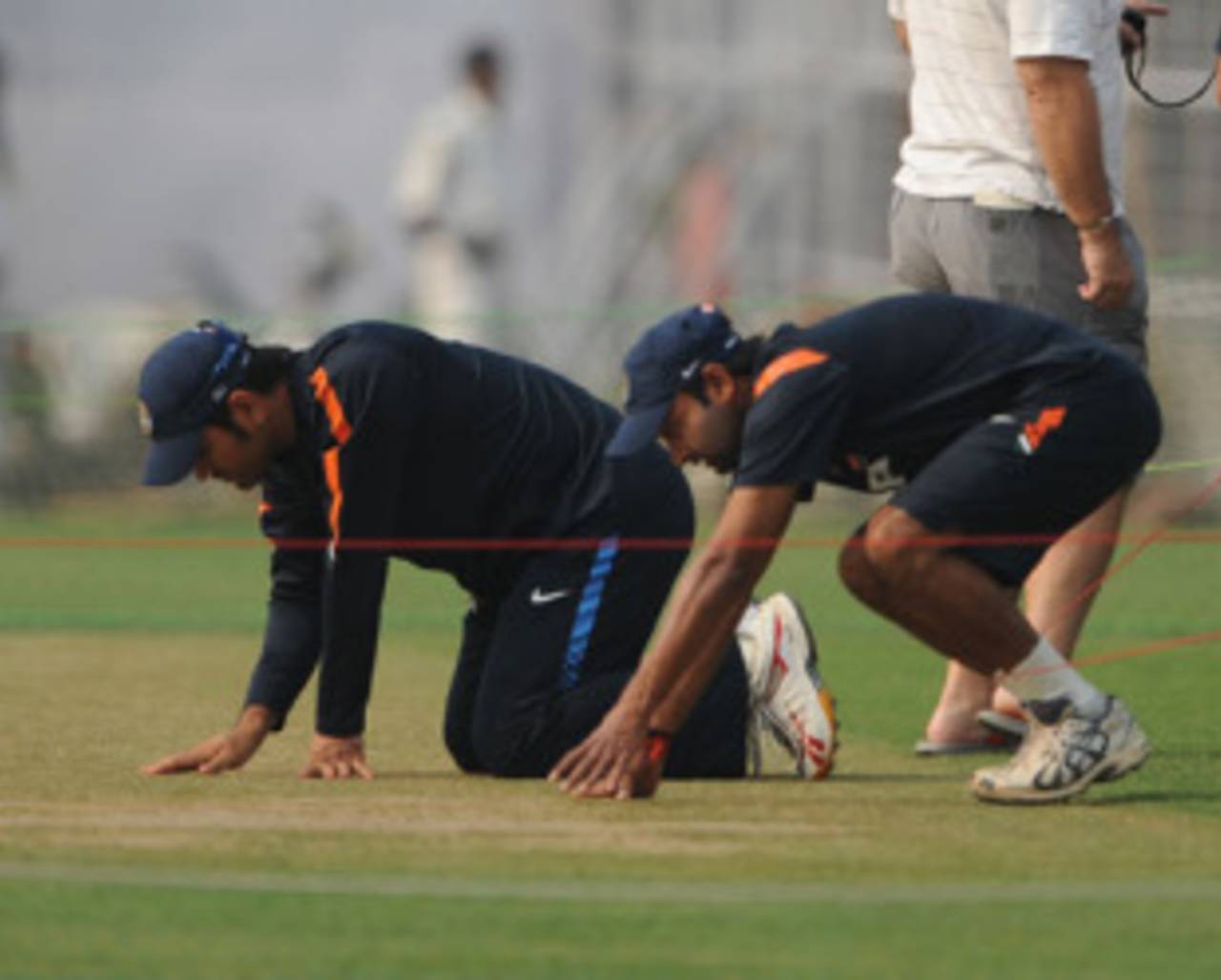 MS Dhoni and Amit Mishra examine the pitch at the Eden Gardens, Kolkata, February 12, 2010