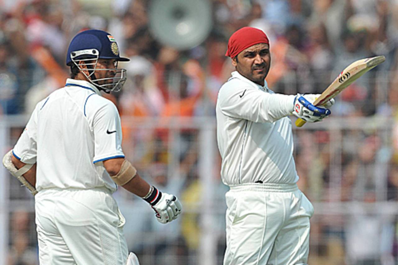 Sachin Tendulkar looks on as Virender Sehwag raises three figures, India v South Africa, 2nd Test, Kolkata, 2nd day, February 15, 2010