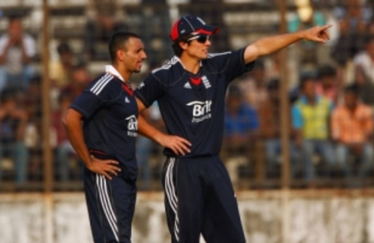 Alastair Cook and Ajmal Shahzad discuss field placings during England's warm-up game, England in Bangladesh, February 23, 2010