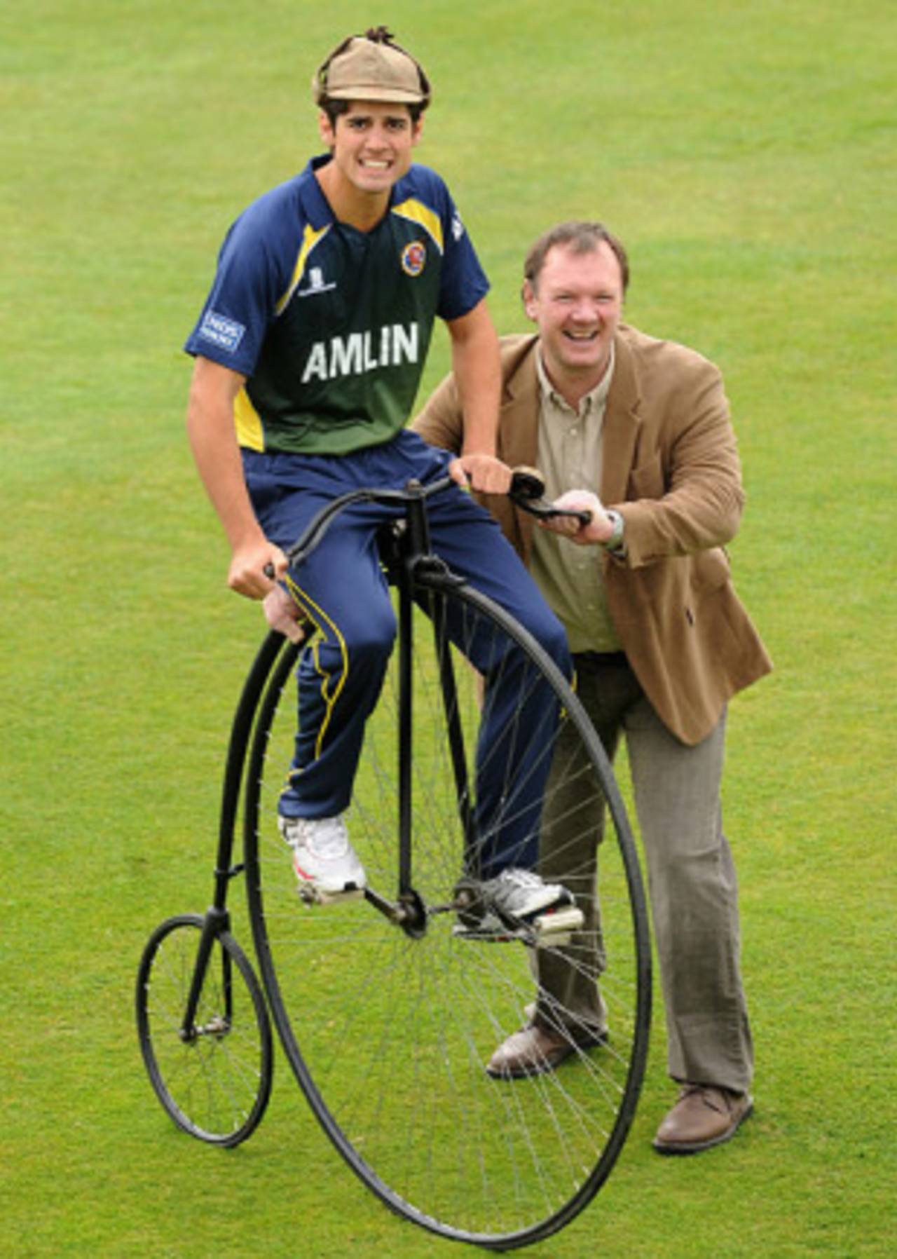 Alastair Cook poses rather unstably on a penny farthing bicycle with charity fundraiser Lloyd Scot, Chelmsford, April 7, 2010