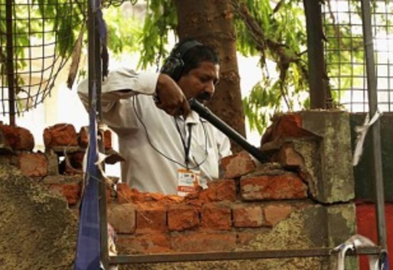 A policeman checks the wall of the Chinnaswamy Stadium where the explosion occurred, Royal Challengers Bangalore V Mumbai Indians, IPL, Bangalore, April 17, 2010