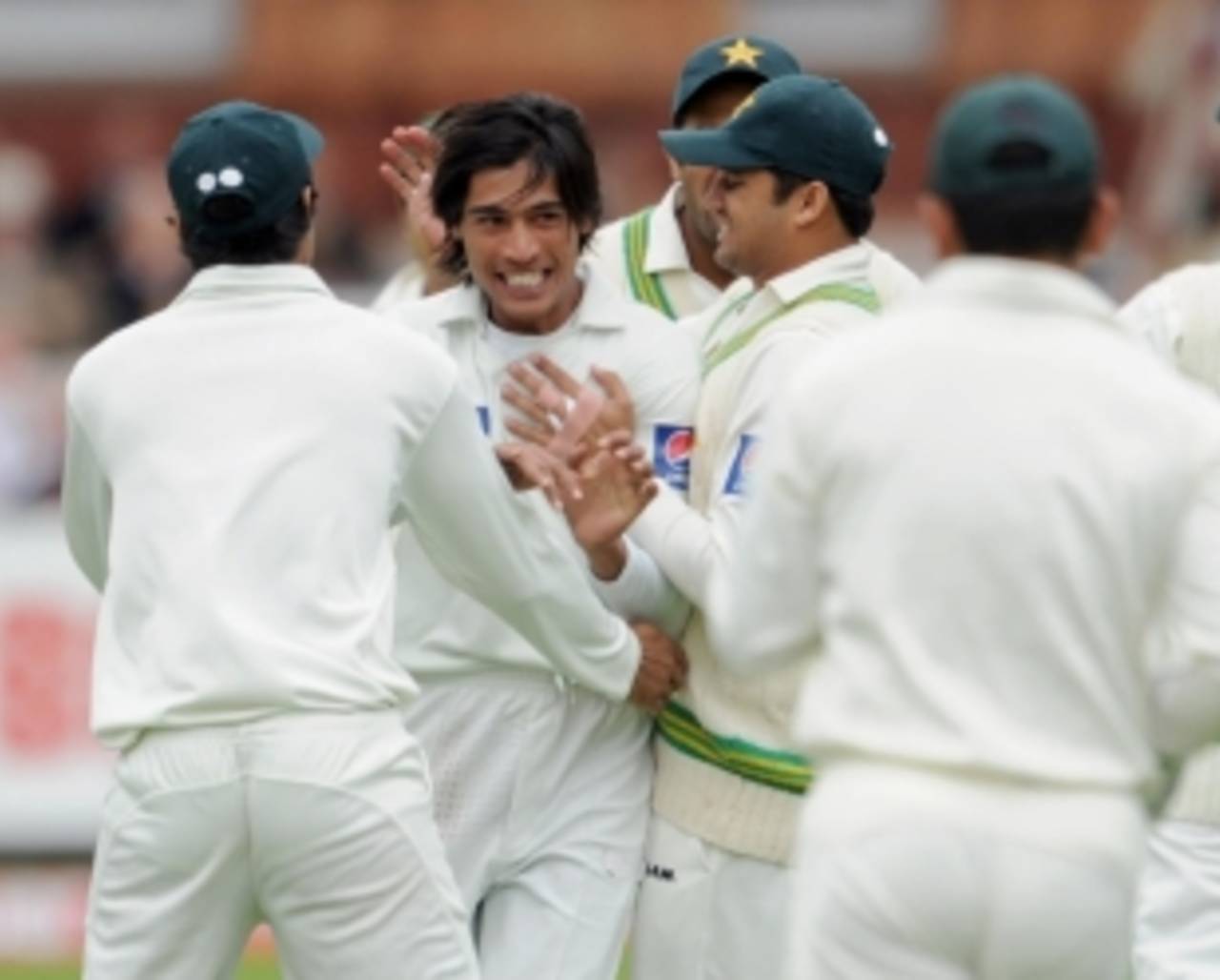 Mohammad Amir is swamped by his team-mates in the midst of his successful spell, England v Pakistan, 4th npower Test, Lord's, August 27 2010