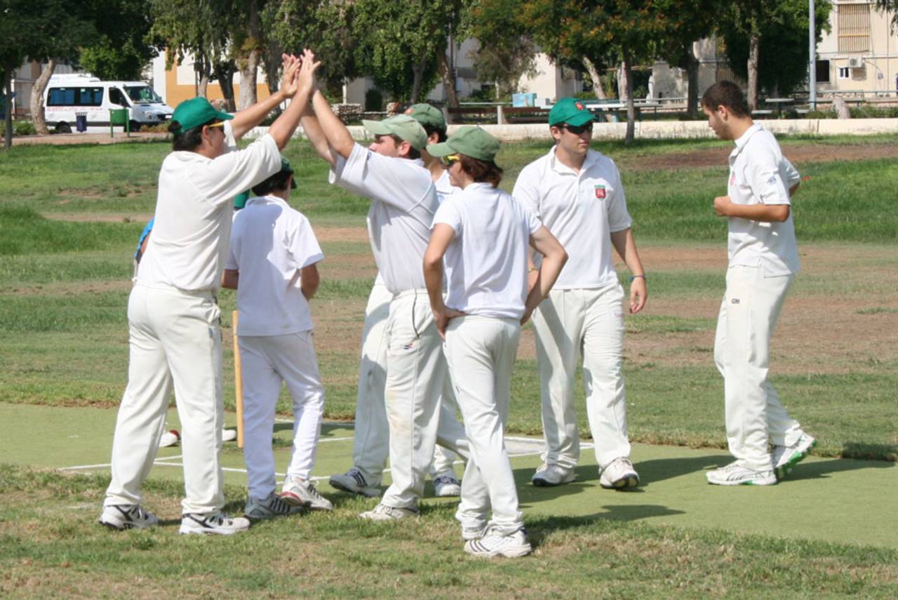 Ra'anana players celebrate the early run out of Gilon Samuels