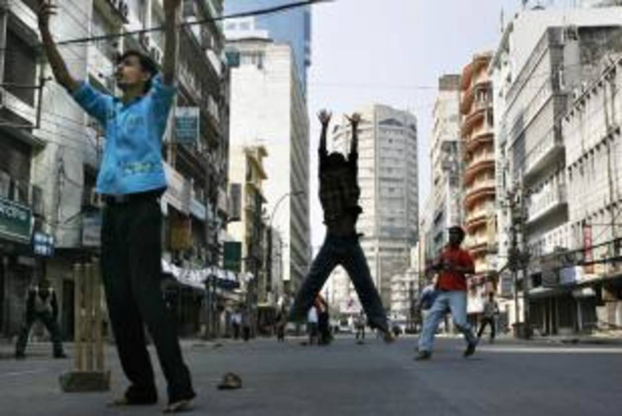 Young men play cricket on a near-empty street in Dhaka on election day, December 29, 2008