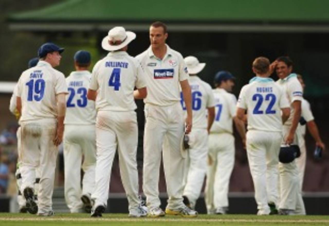 Stuart Clark and his team-mates gather after a wicket, New South Wales v Tasmania, Sheffield Shield, Sydney, 3rd day, November 19, 2009