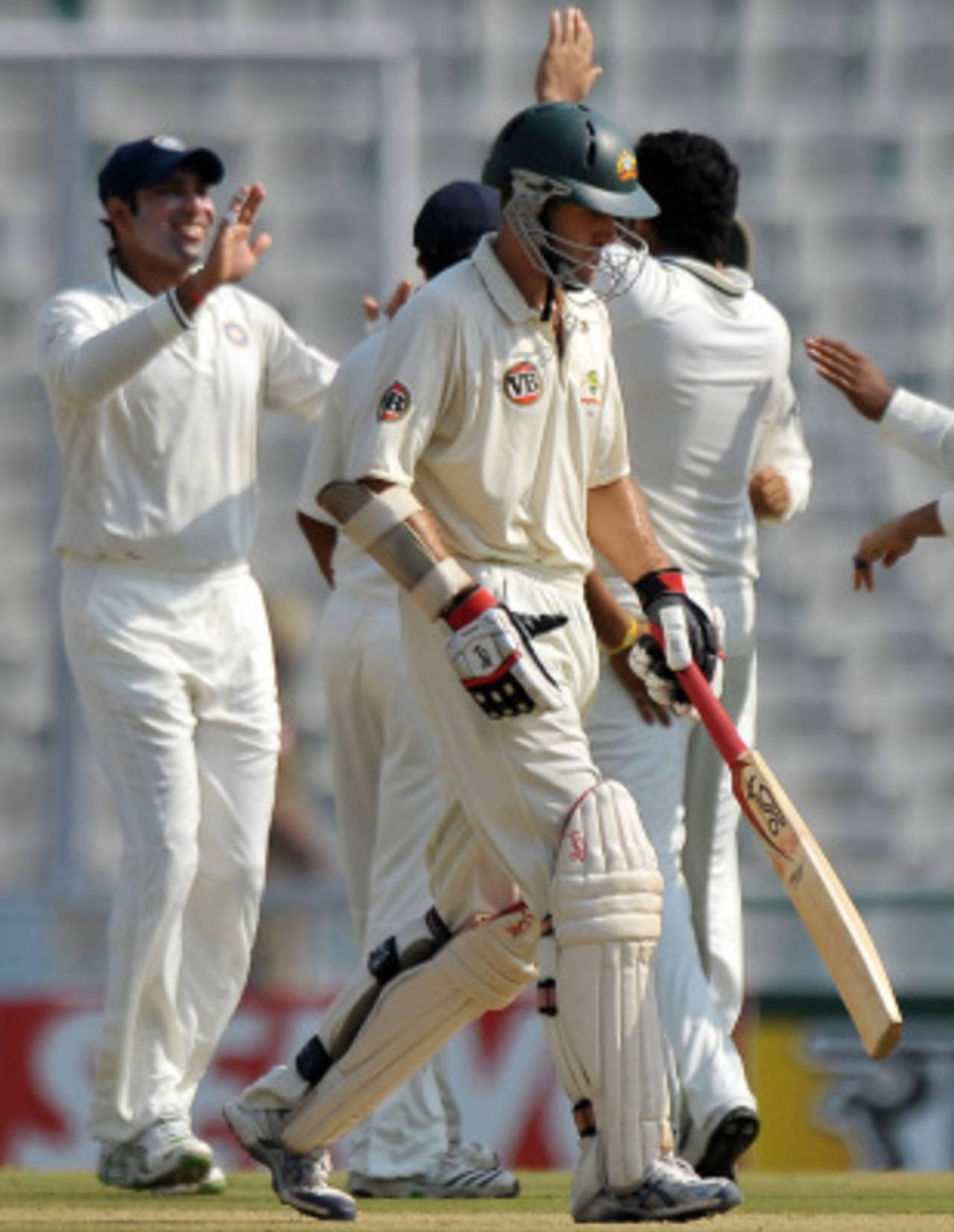 Simon Katich walks back to the pavilion as India's fielders celebrate, India v Australia, 1st Test, Mohali, 1st day, October 1, 2010