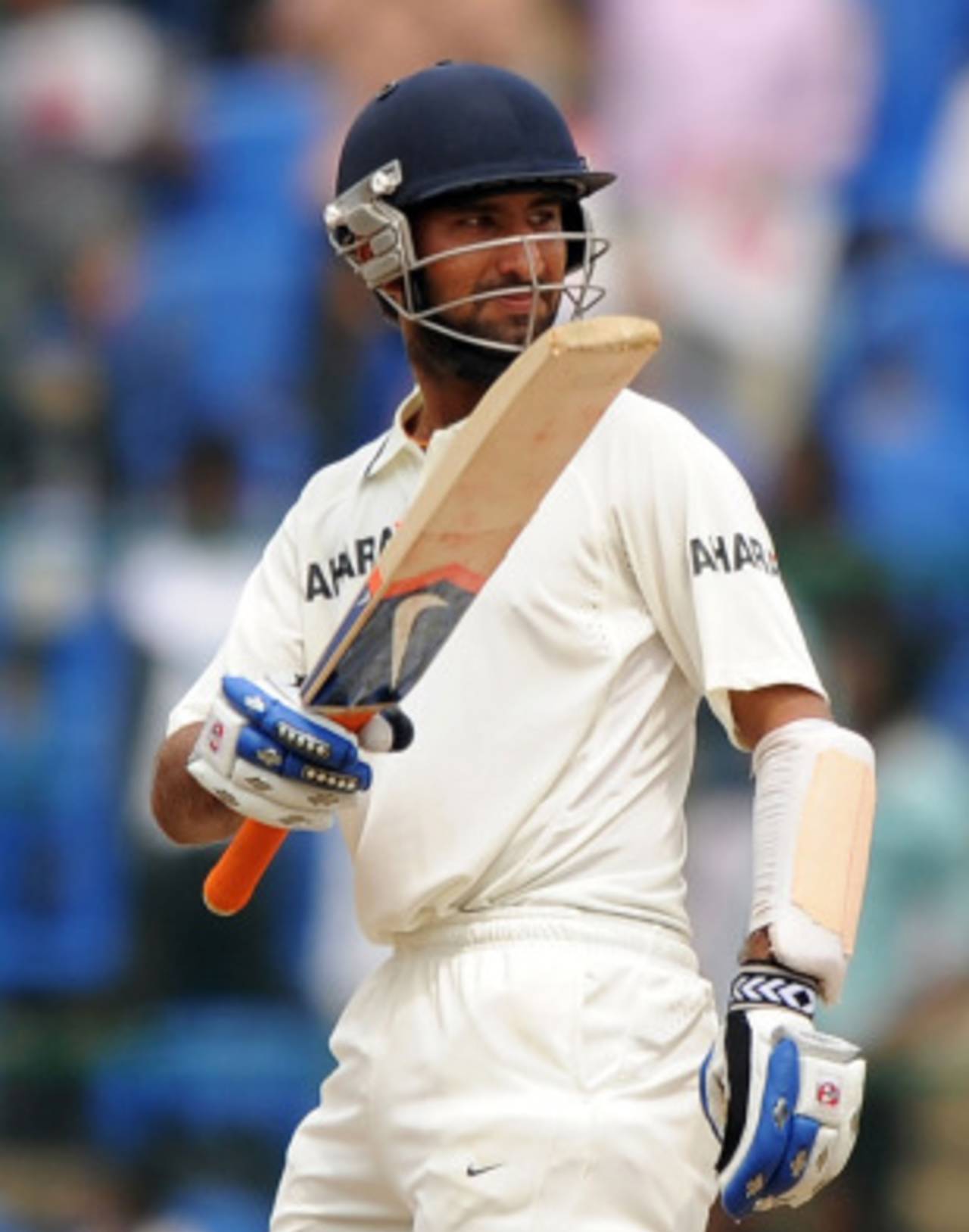 Cheteshwar Pujara raises the bat after reaching his half-century, India v Australia, 2nd Test, 5th day, October 13, 2010