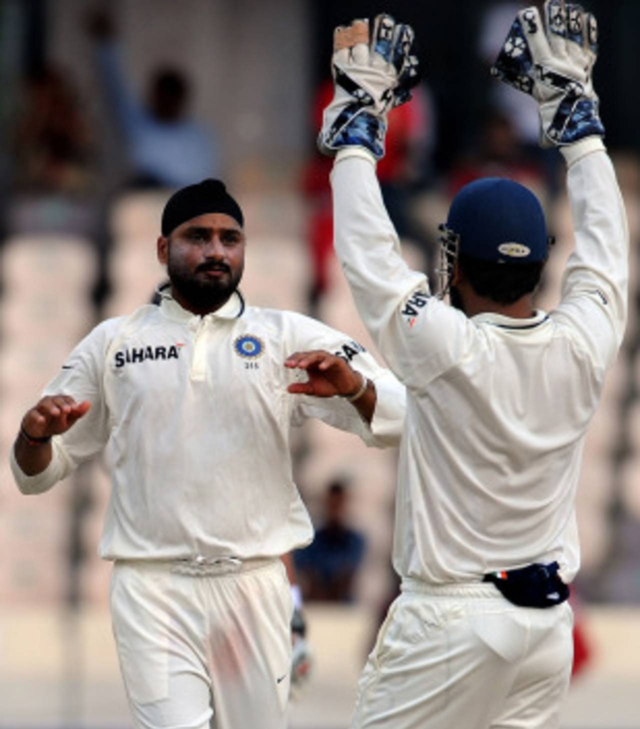 Harbhajan Singh and MS Dhoni celebrate the exit of Daniel Vettori, India v New Zealand, 2nd Test, Hyderabad, 2nd day, November 13, 2010