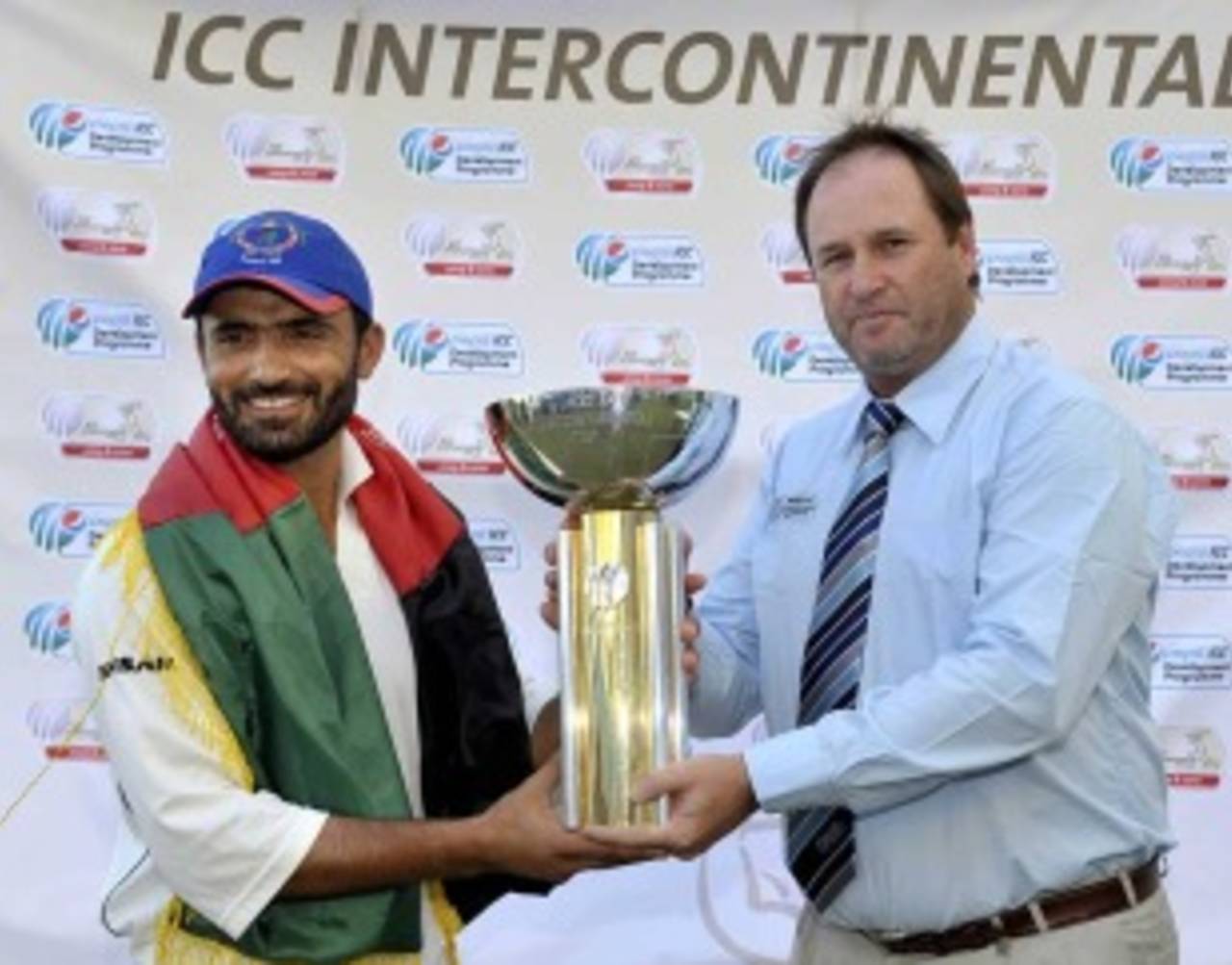 Nawroz Mangal is handed the trophy by ICC's Richard Done after Afghanistan's victory over Scotland&nbsp;&nbsp;&bull;&nbsp;&nbsp;International Cricket Council