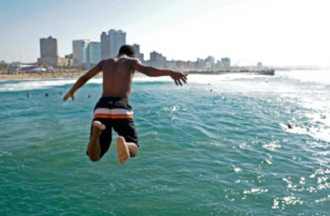 A boy jumps into the sea at South Beach in Durban, June 20, 2010