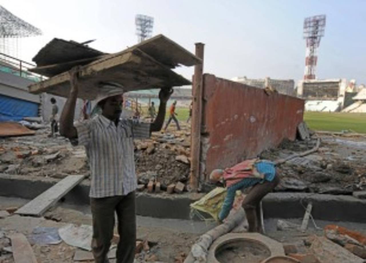 Construction workers remove debris during the renovation of Eden Gardens, Kolkata, January 5, 2011