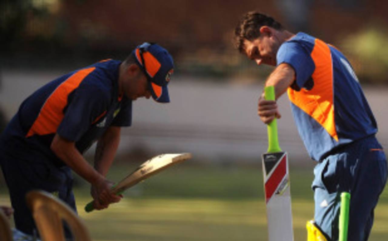 Ricky Ponting and Michael Clarke exchange bats at Australia's training session, Bangalore, February 12, 2011