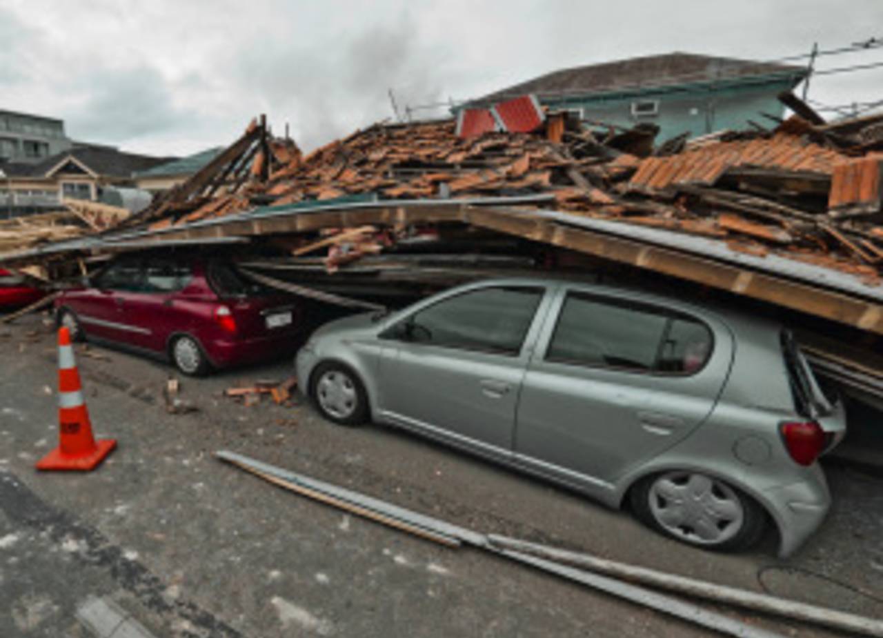 A collapsed building crushes parked cars after a high-intensity earthquake hit Christchurch, February 22, 2011