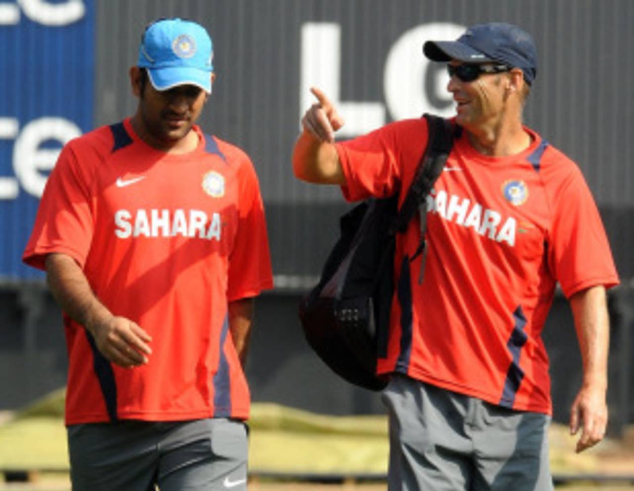 MS Dhoni and Gary Kirsten have a chat while heading for India's training session, Bangalore, February 24, 2011