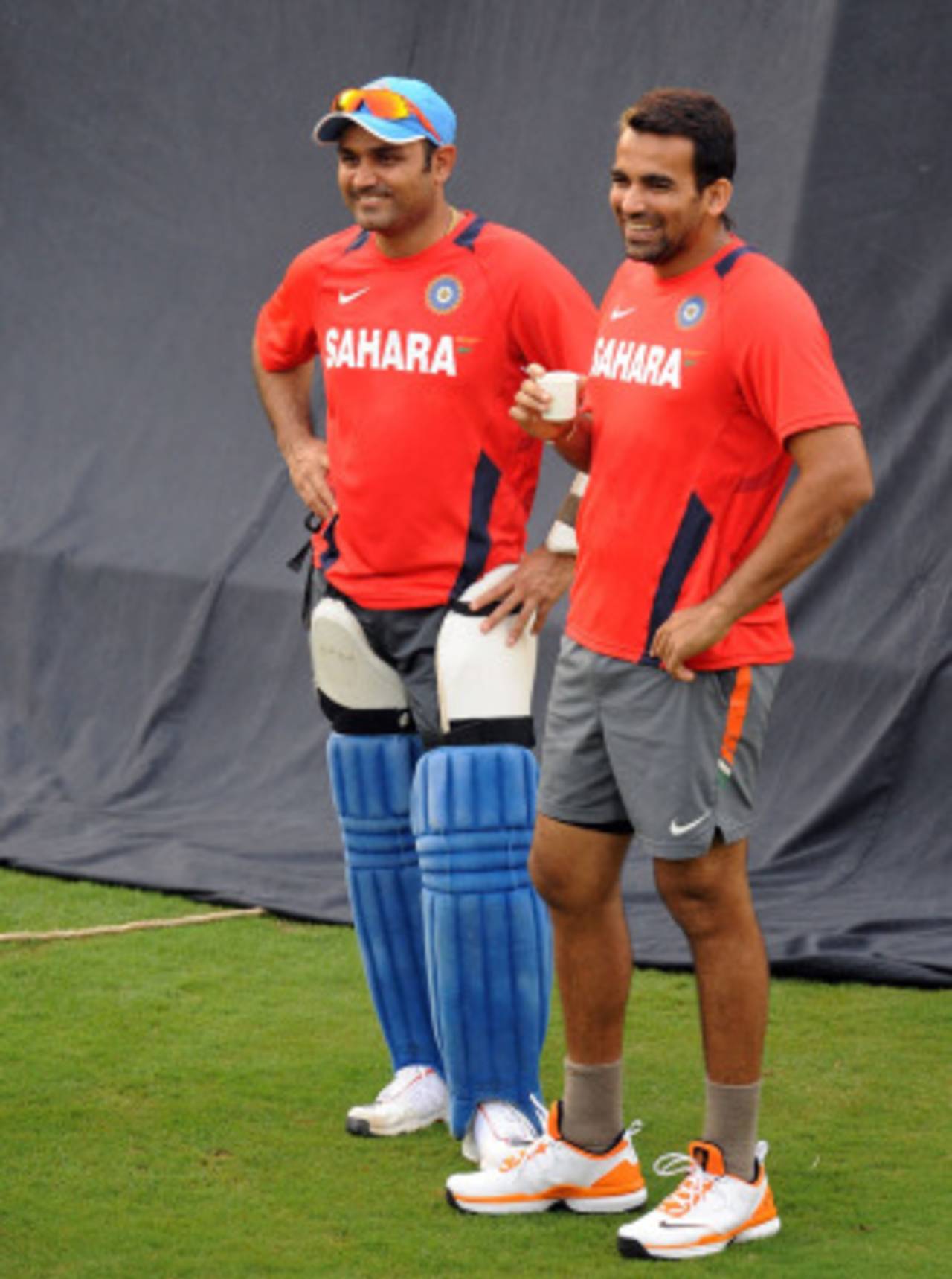 Virender Sehwag and Zaheer Khan watch their team-mates practice, Bangalore, February 26, 2011