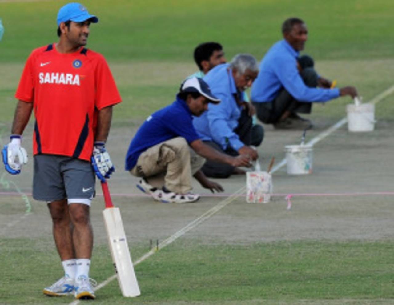MS Dhoni bats during practice as the groundstaff prepares the pitch, Delhi, March 8, 2011
