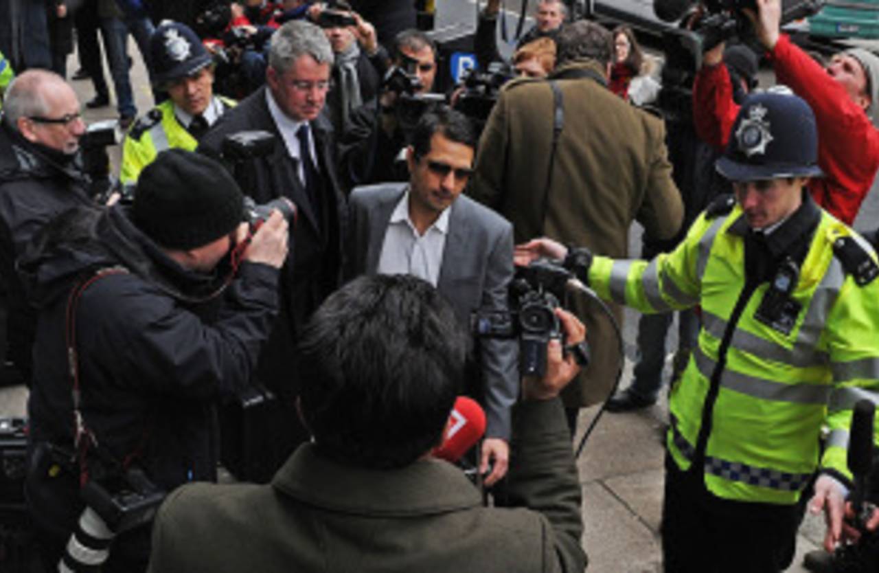 Mazhar Majeed makes his way through a scrum outside court, London, March 17, 2011
