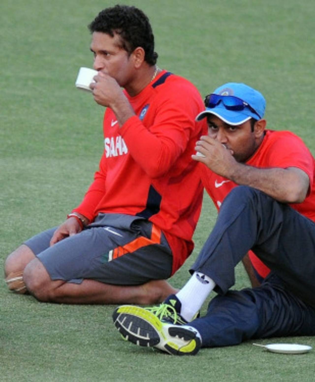 Sachin Tendulkar and Virender Sehwag sip some tea during a break from training, Mohali, March 27, 2010