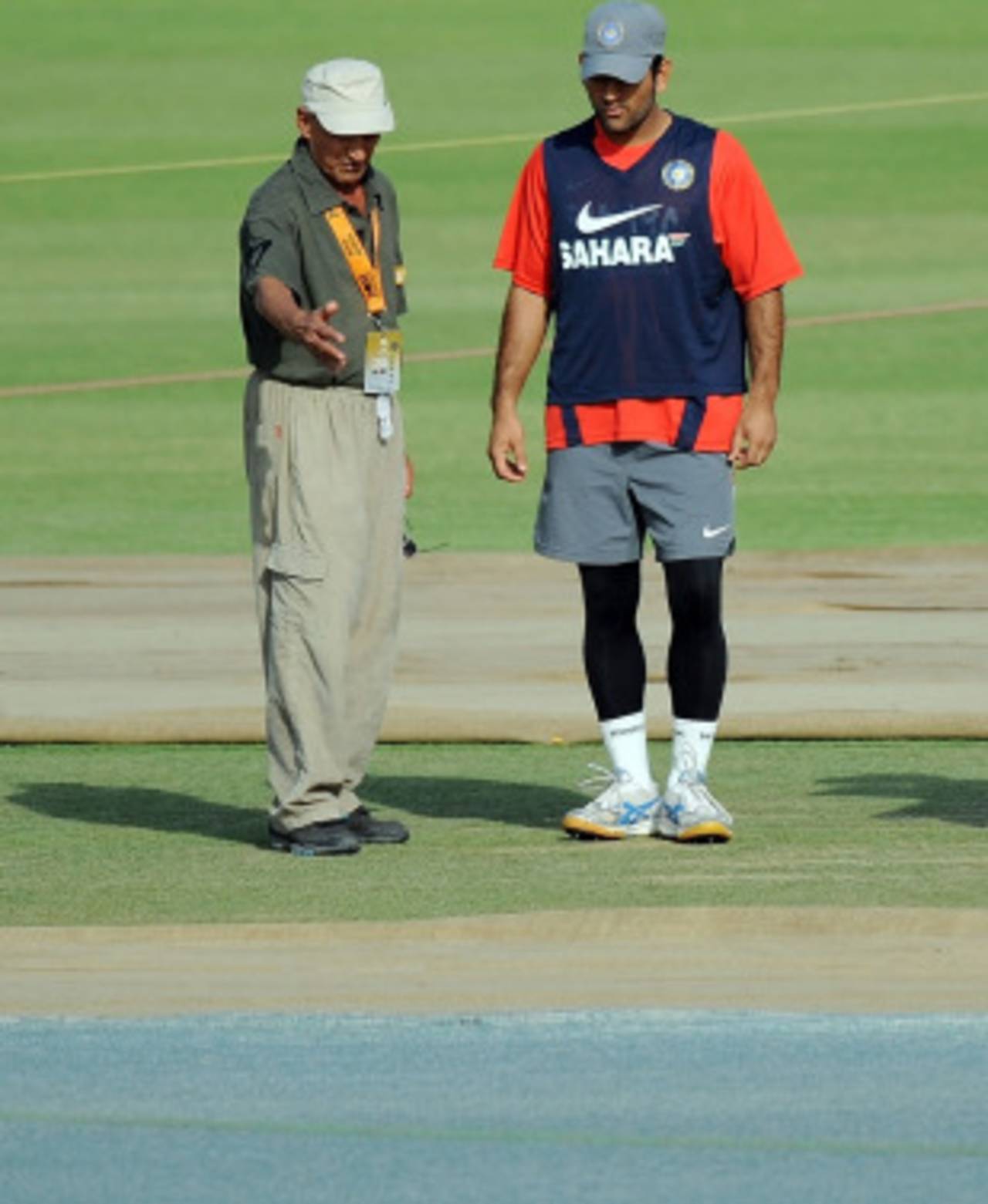 MS Dhoni and curator Daljit Singh inspect the Mohali pitch, Mohali, March 27, 2010