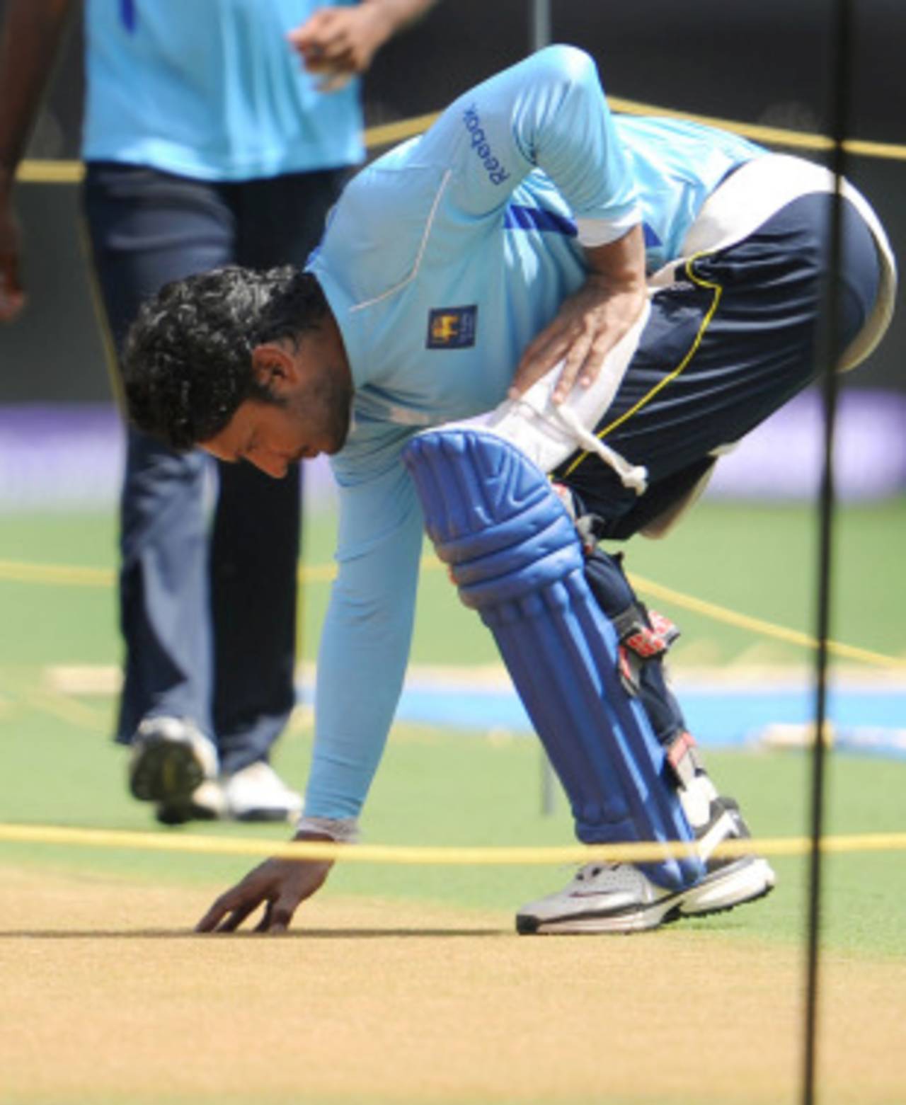 Kumar Sangakkara takes a close look at the pitch laid out for the final, Mumbai, April 1, 2011