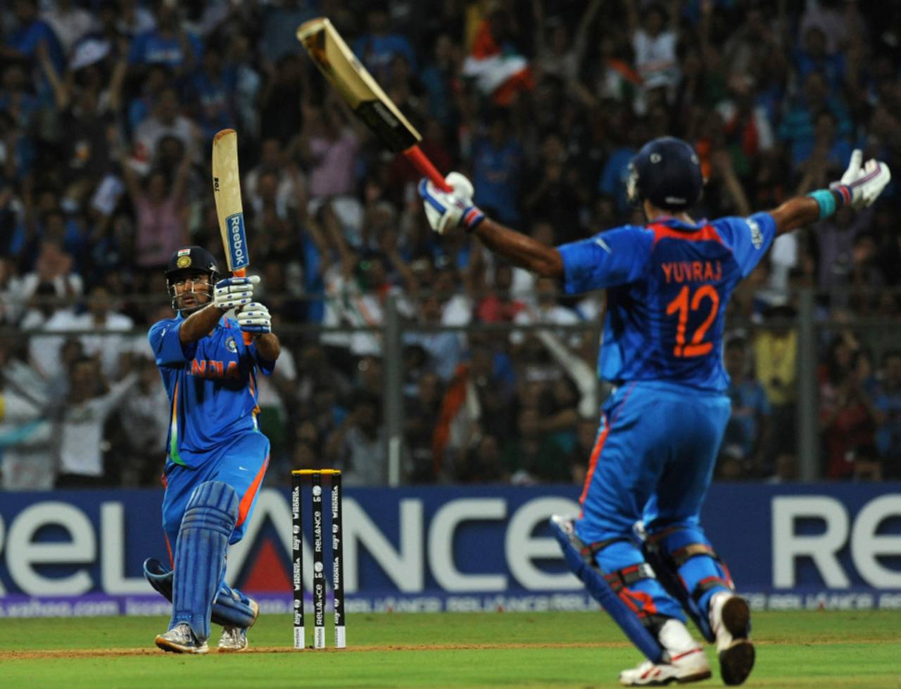 MS Dhoni watches the winning six sail over the boundary as Yuvraj Singh raises his arms in triumph, India v Sri Lanka, final, World Cup 2011, Mumbai, April 2, 2011