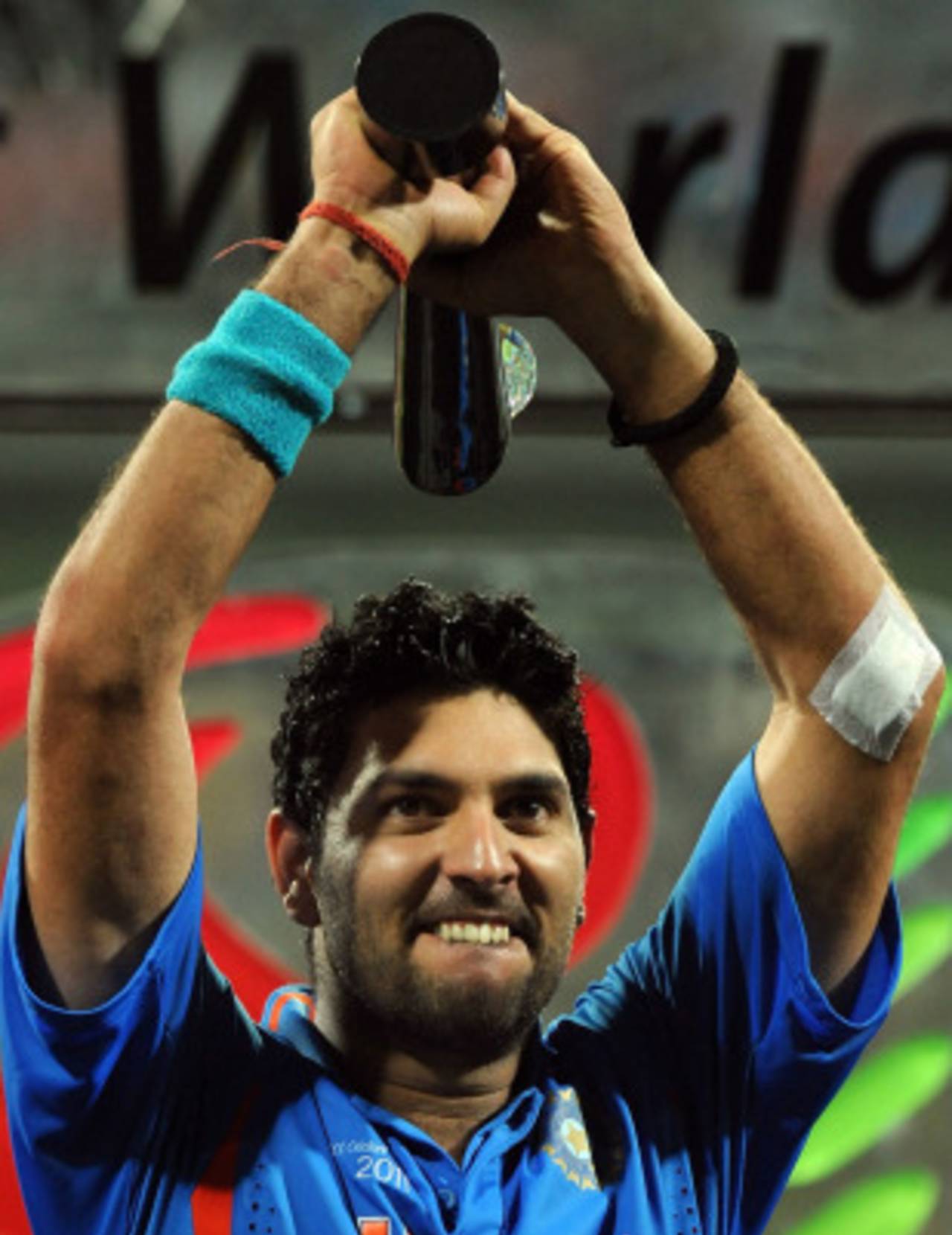 A proud Yuvraj Singh holds the World Cup Player of the Tournament trophy aloft&nbsp;&nbsp;&bull;&nbsp;&nbsp;AFP
