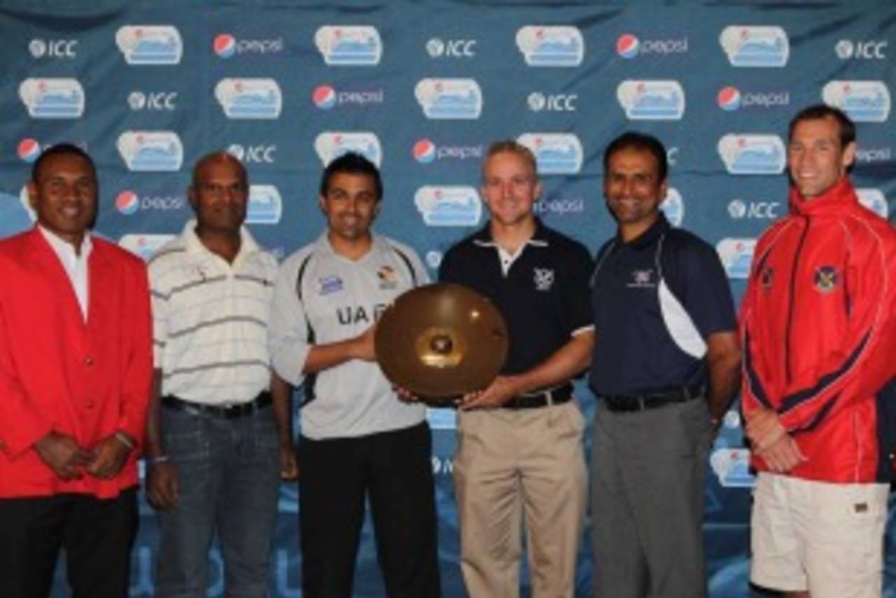 The captains of the teams participating in the WCL Division 2 pose with the trophy, Dubai, April 7, 2011