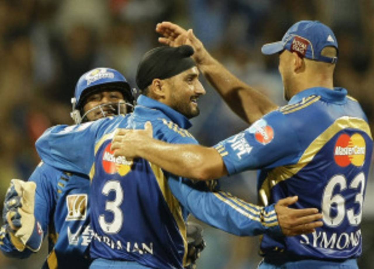 Harbhajan Singh is congratulated by Andrew Symonds for getting Suresh Raina, Mumbai Indians v Chennai Super Kings, IPL 2011, Mumbai, April 22, 2011