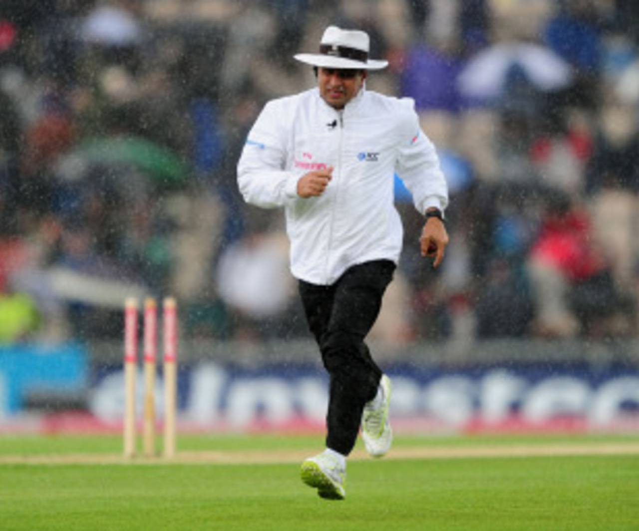 Aleem Dar runs for cover as the rain falls again, England v Sri Lanka, 3rd Test, Rose Bowl, June 16, 2011