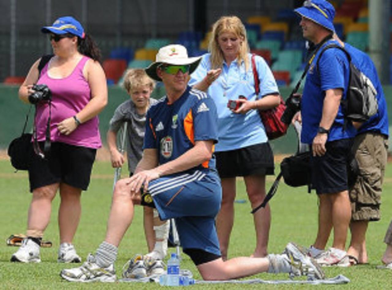 Brett Lee stretches as he is watched by fans during a training session, Colombo, August 1, 2011